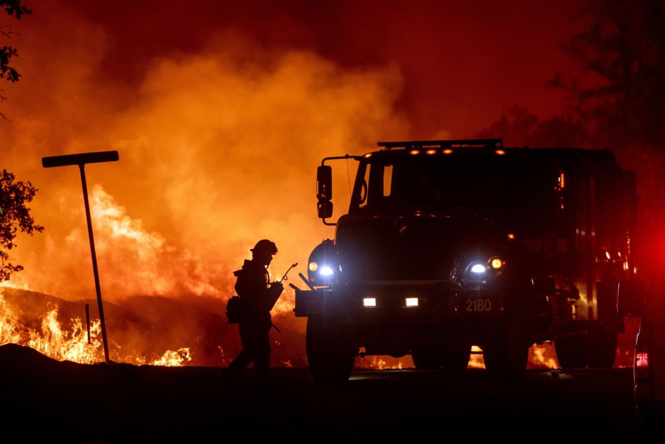 Firefighters battle the Carr Fire line in the Lake Keswick Estates area of Redding., USA.  