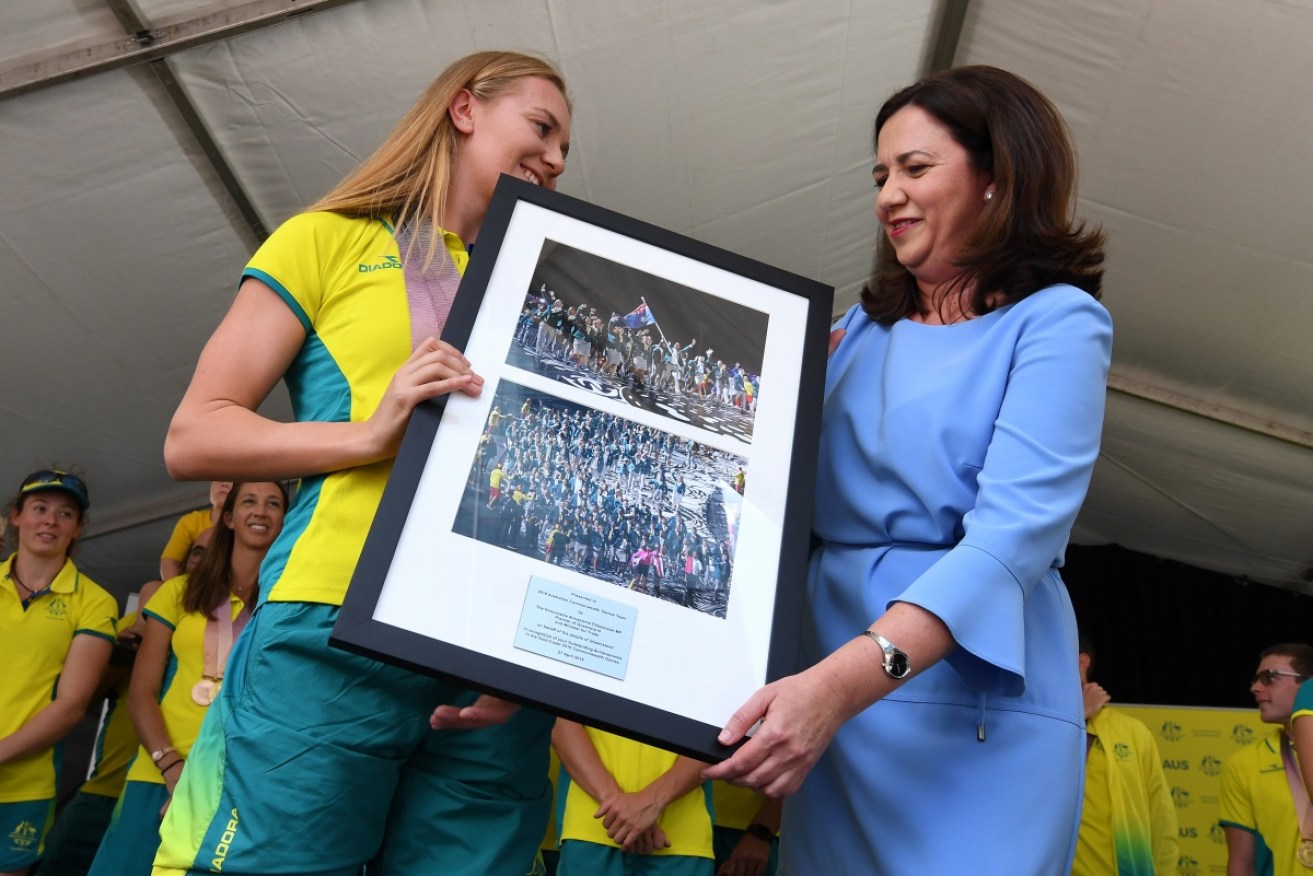 Commonwealth Games gold medallist swimmer Ariarne Titmus receives a gift from Premier Annastacia Palaszczuk.