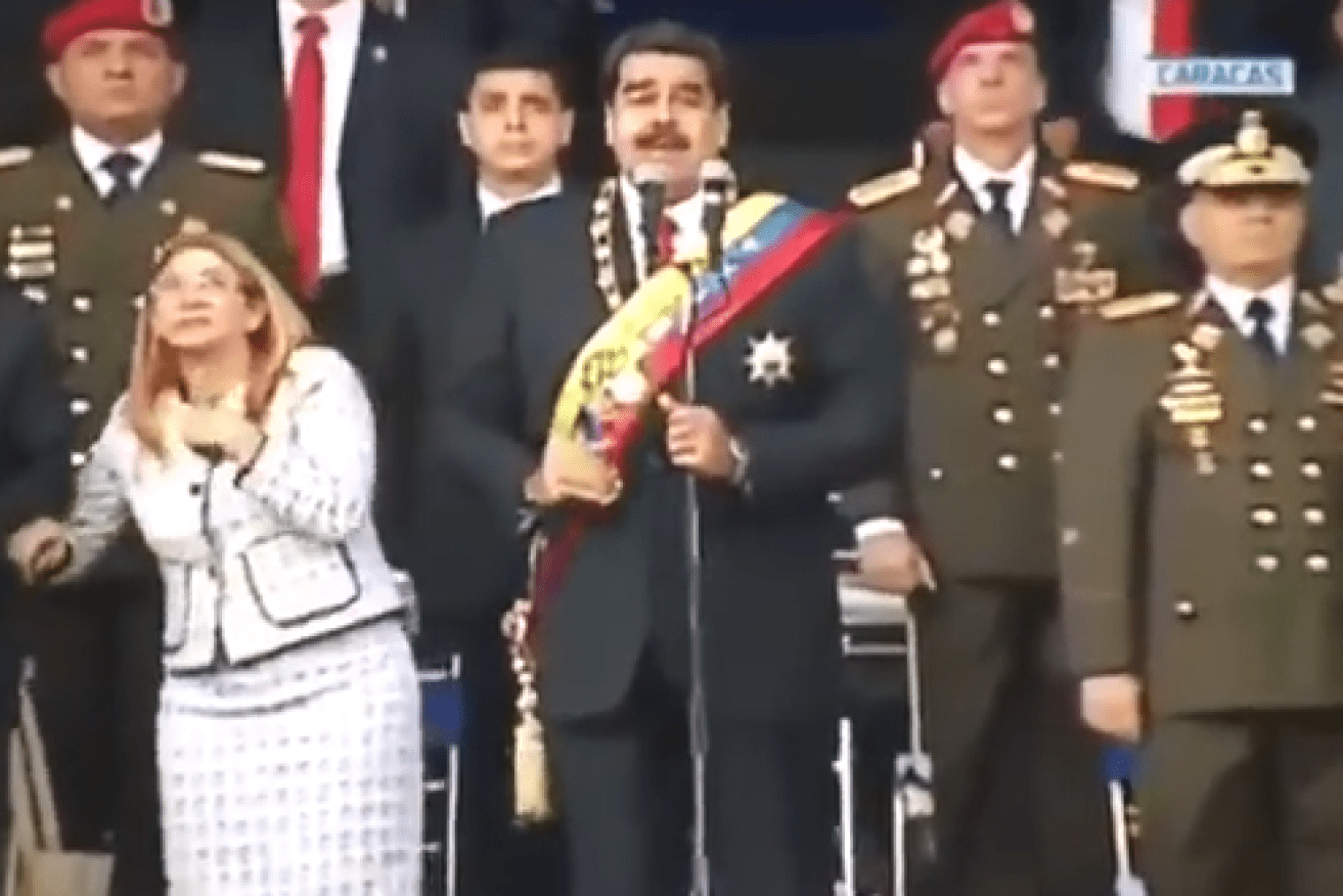 Venezuela's First Lady Cilia Flores recoils in terror as the first drone explodes.