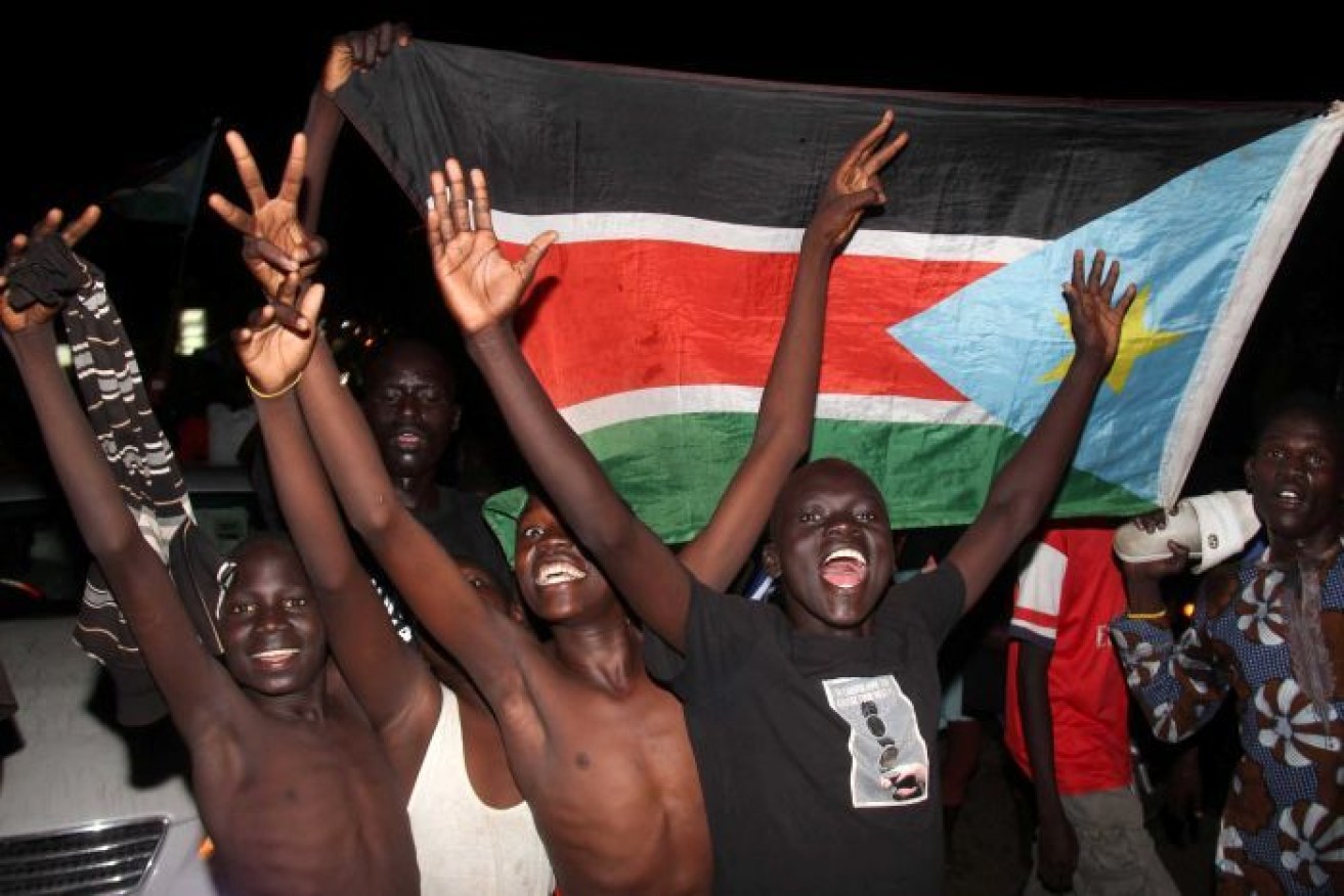 Children celebrate in the  street after South Sudan peace deal. 