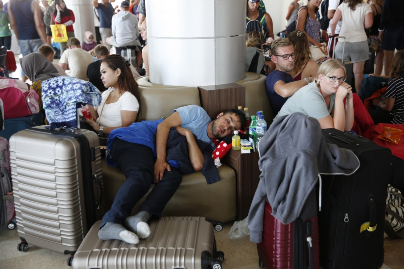 Stranded passengers wait at Lombok's Praya International Airport.