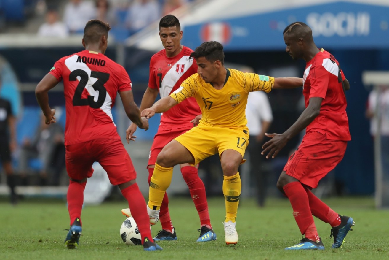 Daniel Arzani is surrounded by Peruvian opponents at the World Cup in Russia.  