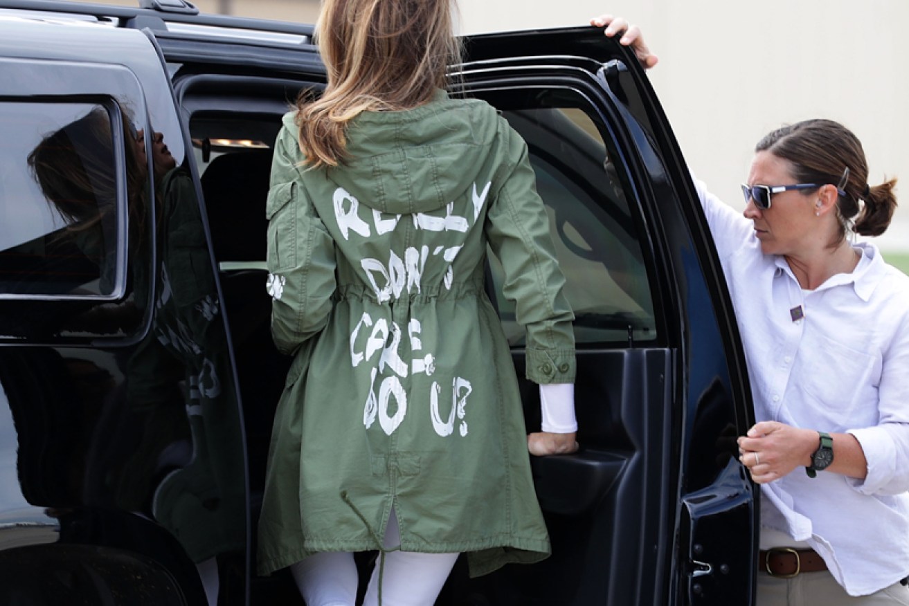 US first lady Melania Trump climbs back into her car in her slogan parka after her Texas visit on June 21.