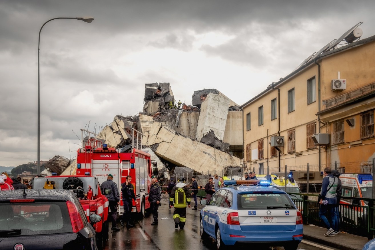 Rescuers work to search for survivors after a section of the Morandi motorway bridge collapsed in Genoa, Italy.