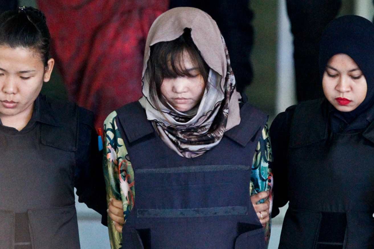 One of the accused, Doan Thi Huong, is escorted by police from a court hearing in Shah Alam, Malaysia.