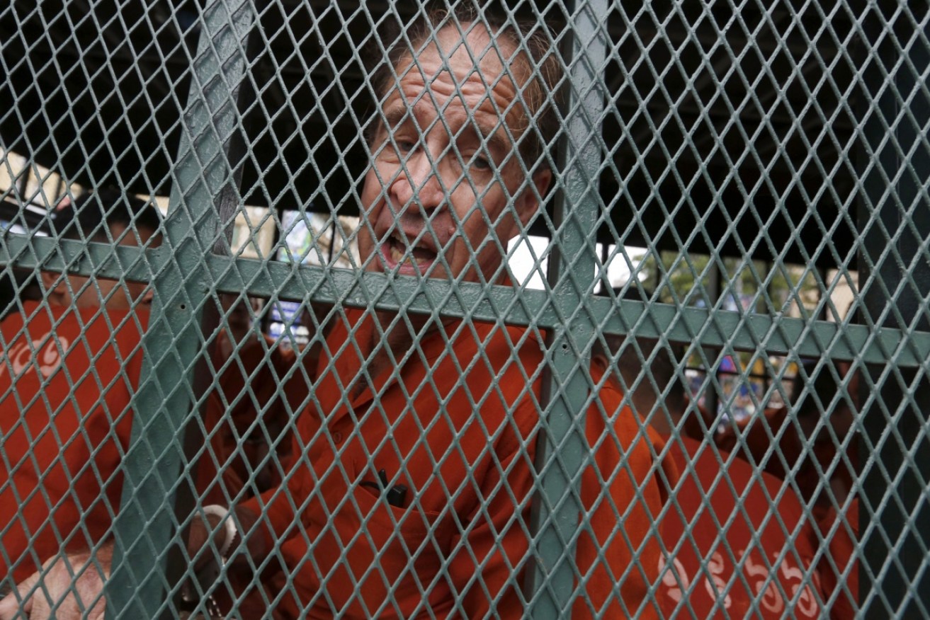 James Ricketson called out from a prison van as it pulled through a throng of media.