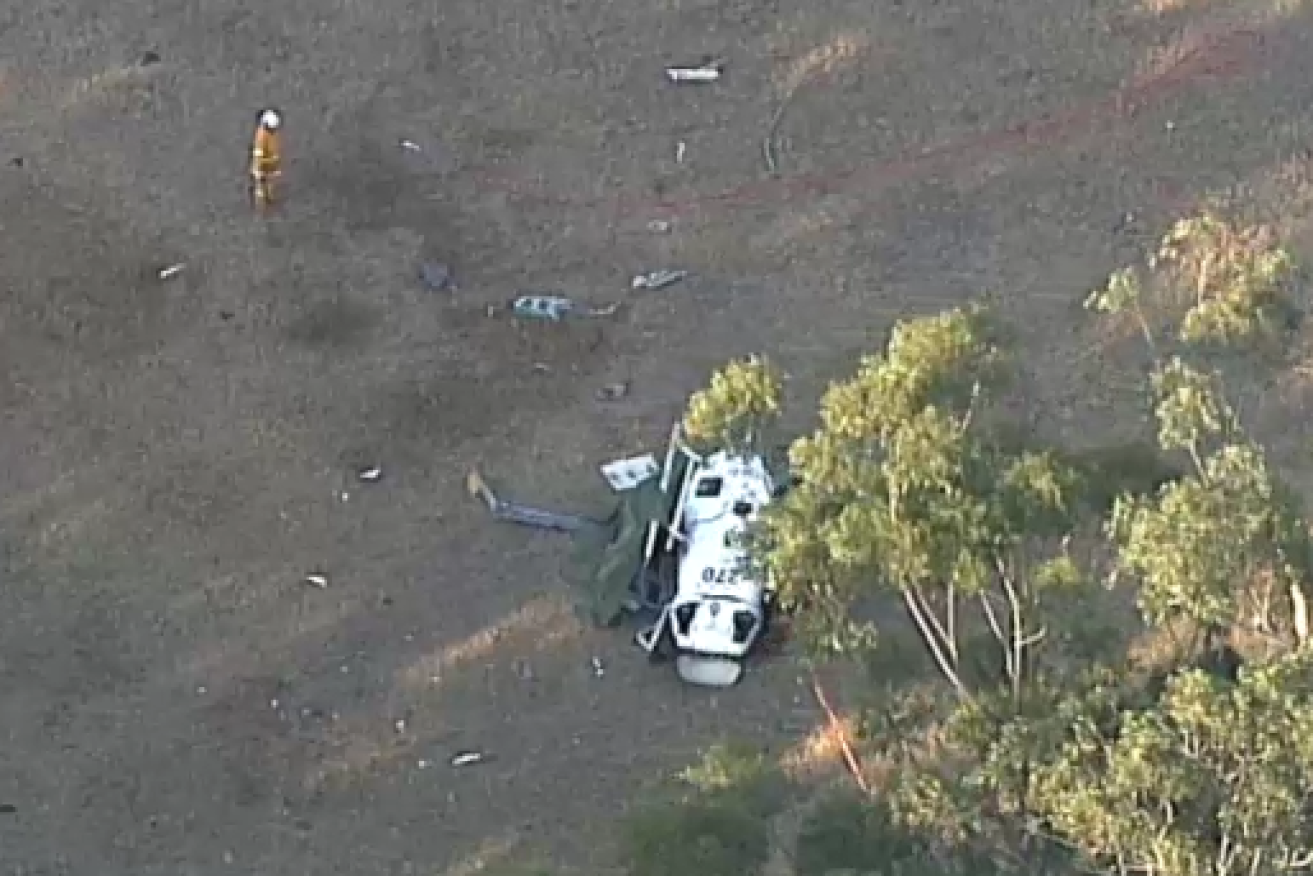 It's tail section and rotor torn off, what's left of the helicoper rests in a South Coast paddock.