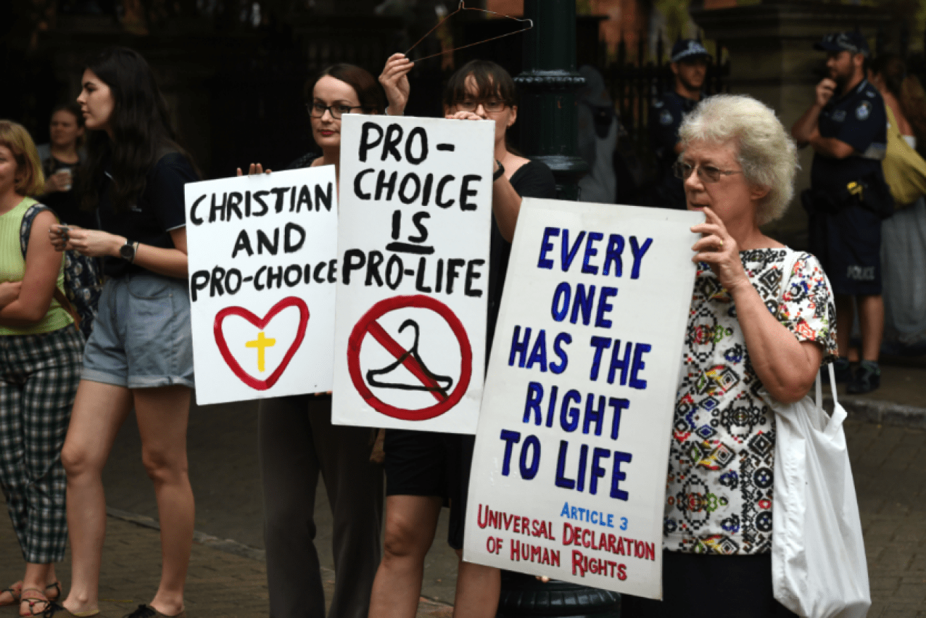 Abortion law protesters, both pro and con, make their views heard at this 2016 rally.