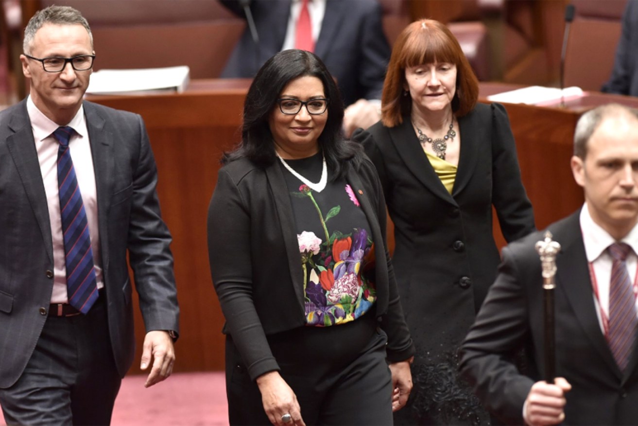 Mehreen Faruqi (centre) is sworn in as the country's first female Muslim senator.