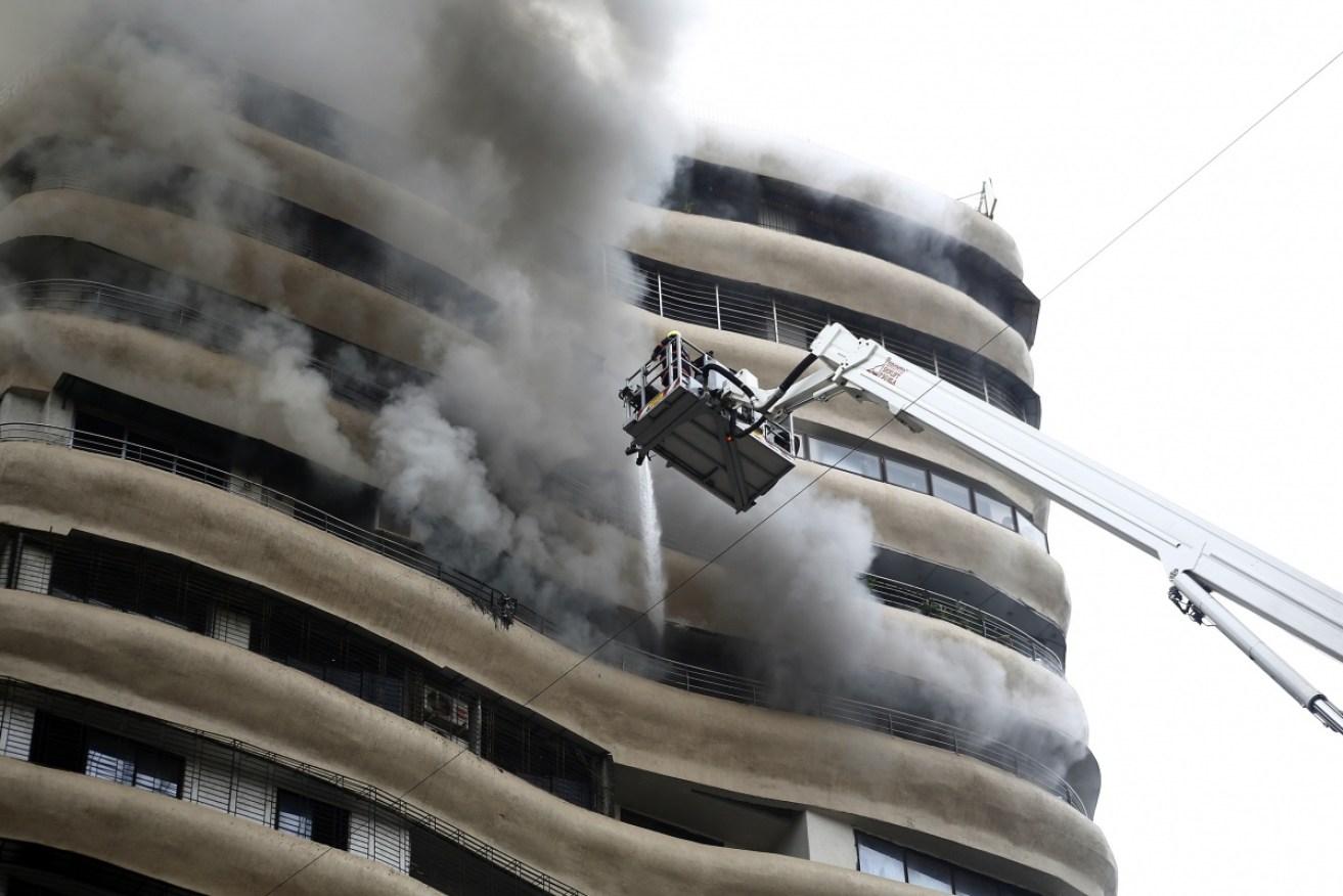 Smoke emits from the 12th floor of residential building Crystal Tower in Mumbai.