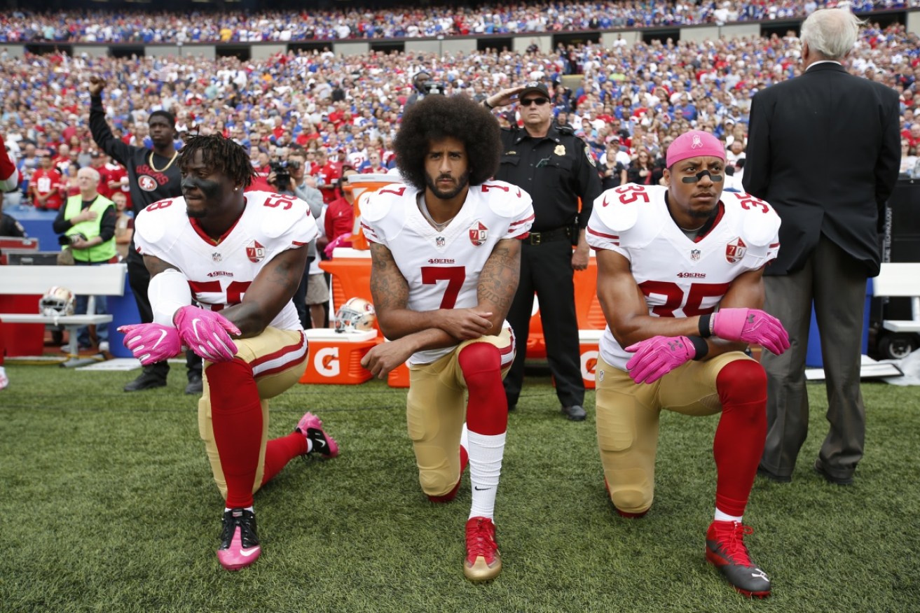 Colin Kaepernick, centre, has been without an NFL team since becoming a symbol of the ant-anthem movement.