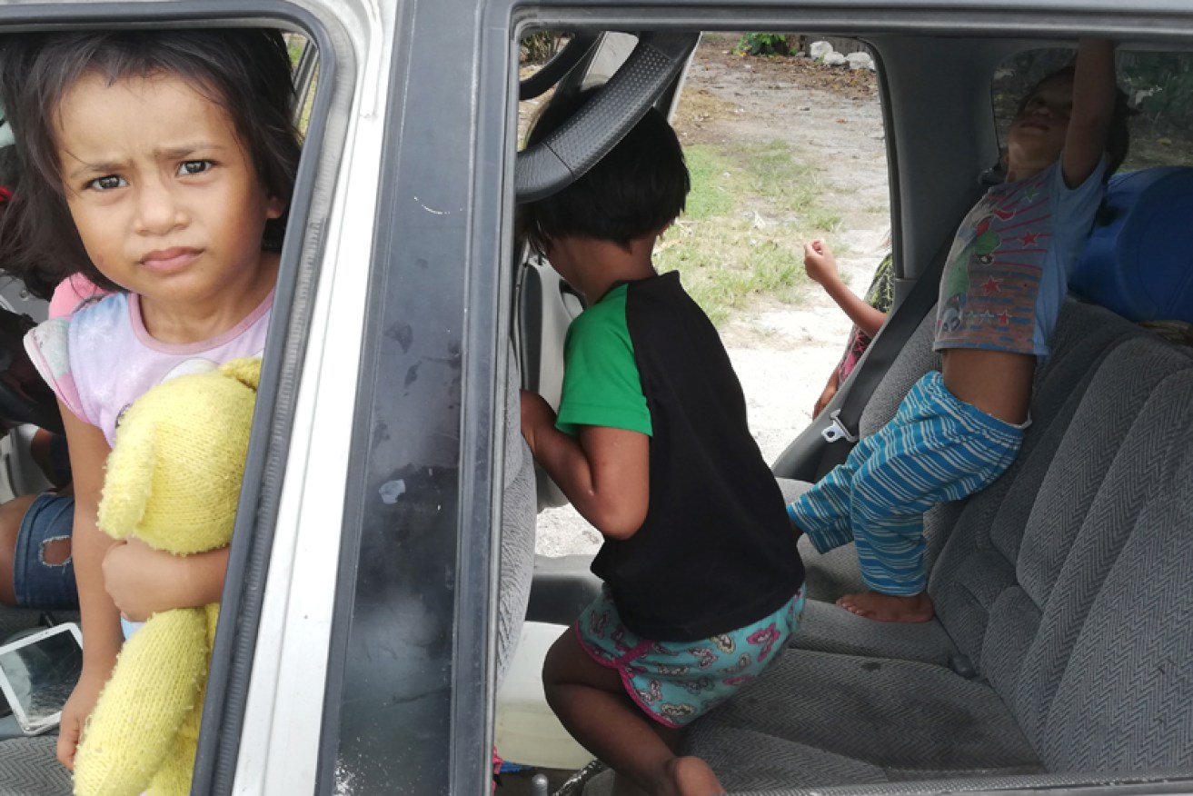 Nauruan children play in a car ahead of the 18-nation Pacific Islands Forum that began on Monday.