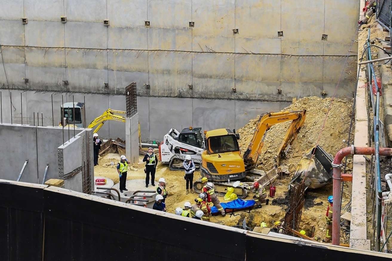 Emergency service workers survey the accident scene at a construction site in Box Hill on September 6.