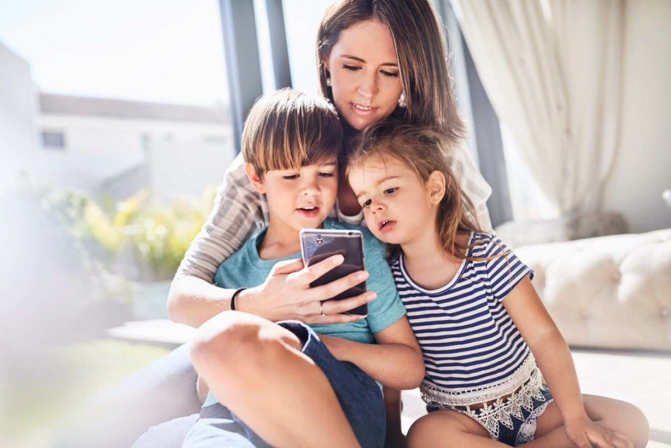 Experts are advising parents to monitor their own screen time to lead by example for their children.
