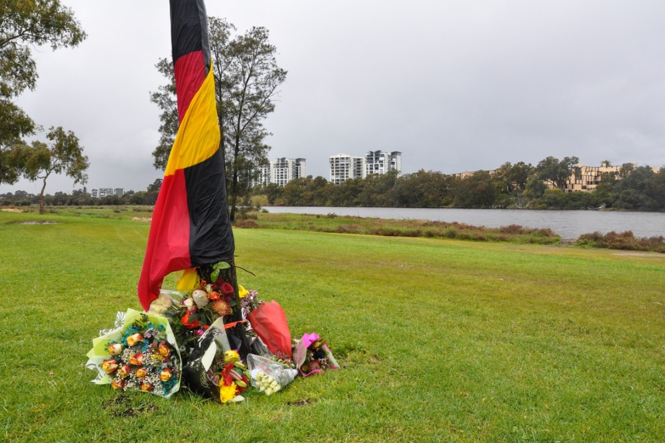 Floral tributes and letters of sympathy at the site where two Aboriginal boys jumped into the water after being chased by police on Monday, then drowned. 