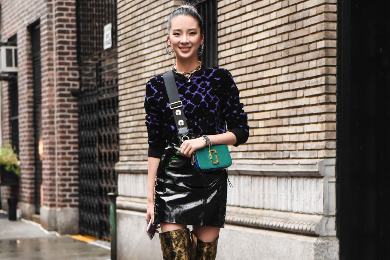 Irene Kim wearing a Marc Jacobs top and Chanel boots.