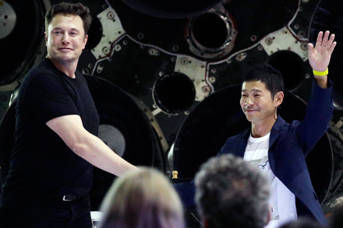 SpaceX's Elon Musk shakes hands with Japanese Yusaku Maezawa after announcing him as the company's first lunar passenger.