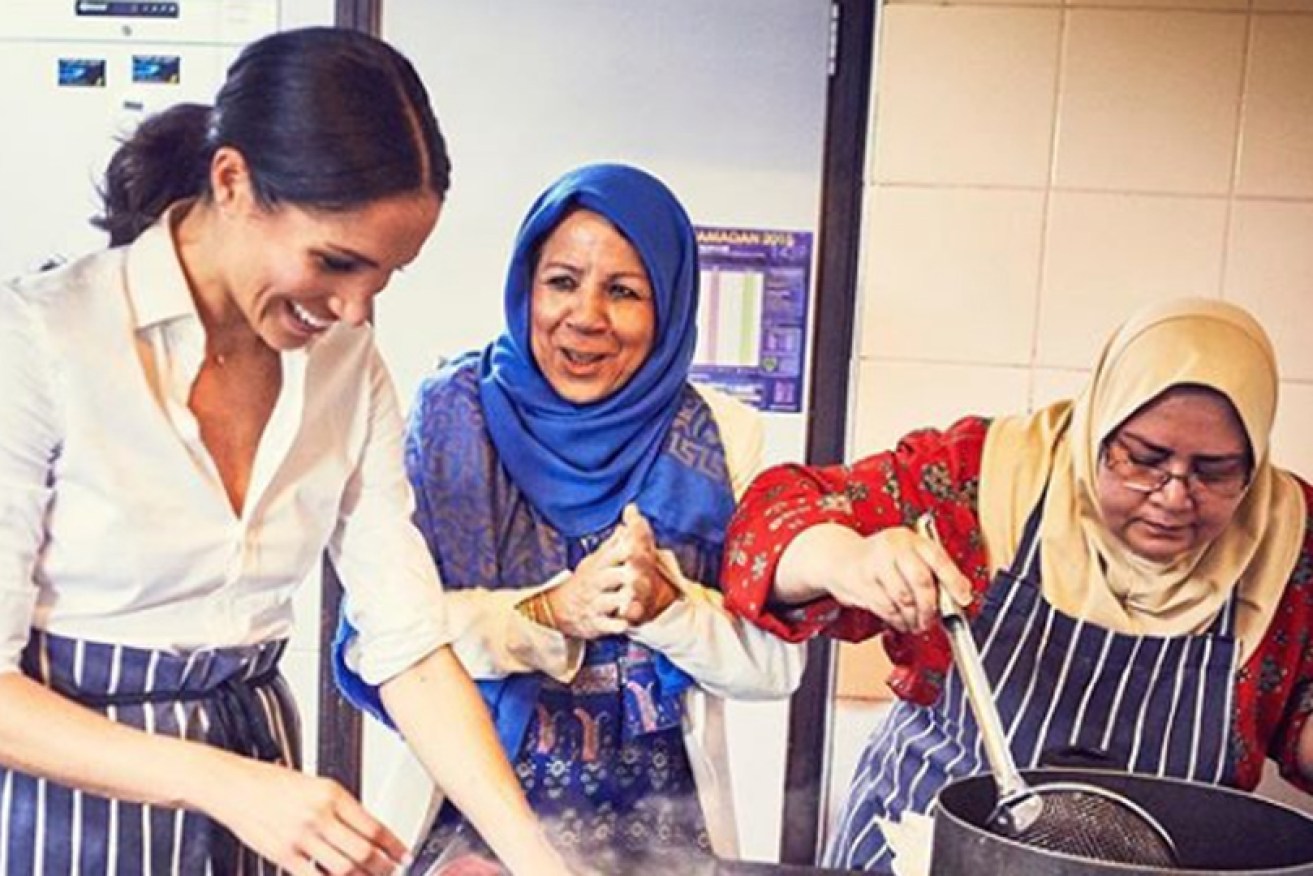 Meghan Markle, the Duchess of Sussex, cooks chapatis and rice in a London community kitchen.