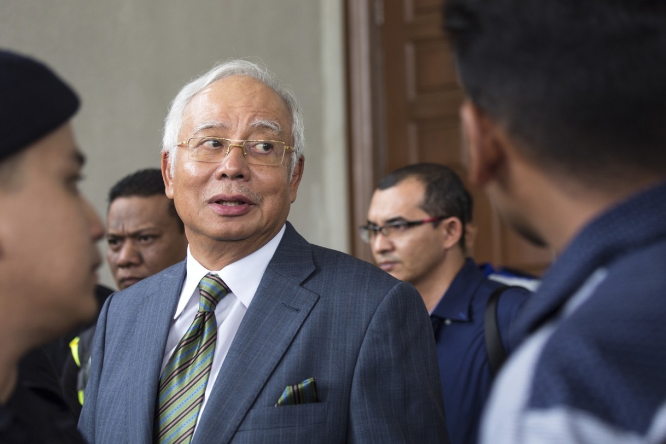 Malaysia's former prime minister Najib Razak exits the Kuala Lumpur High Court on August 8 after being charged with three counts of money laundering.