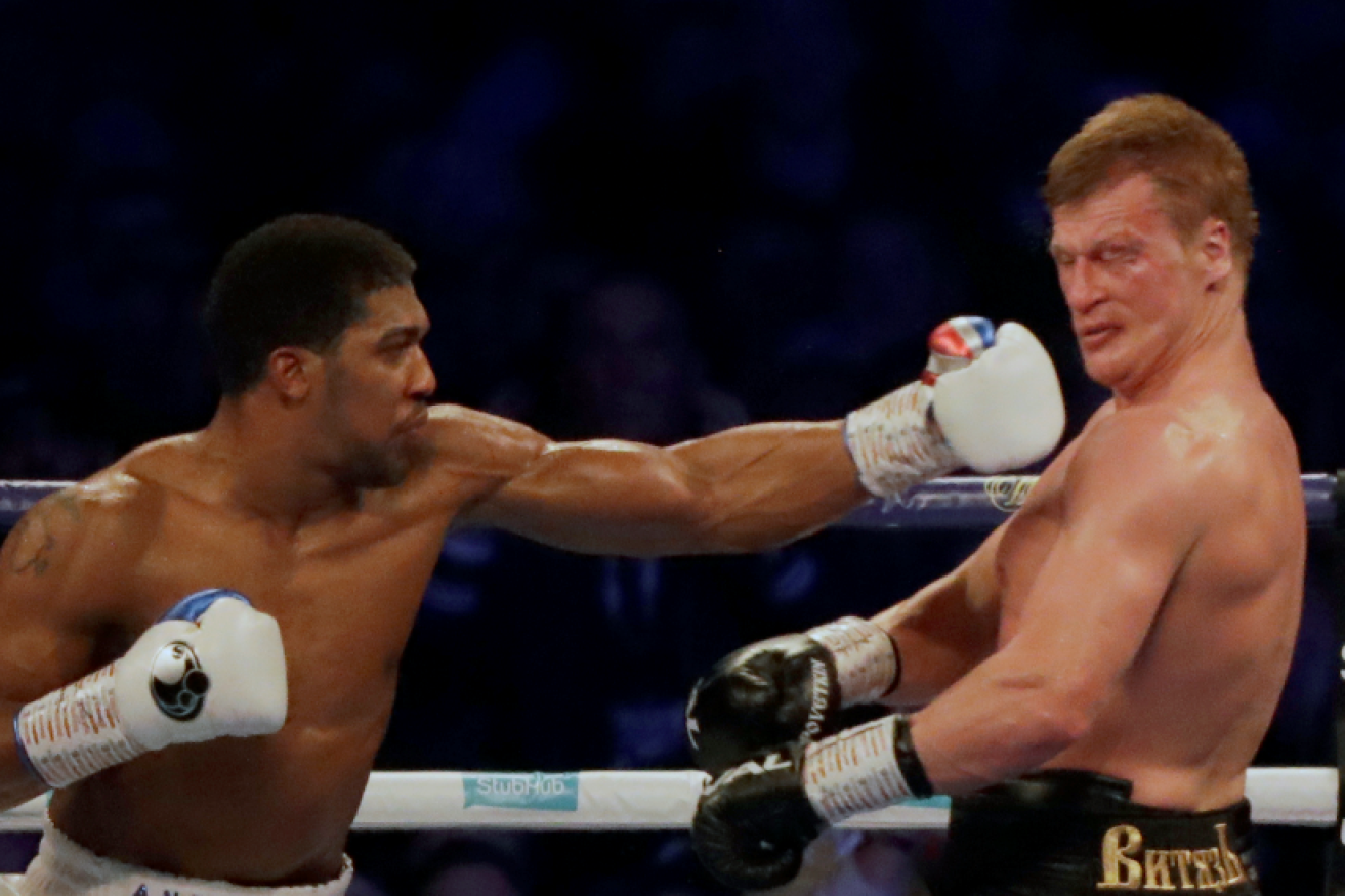 Anthony Joshua knocks Alexander Povetkin title hopes for six in the seventh round.