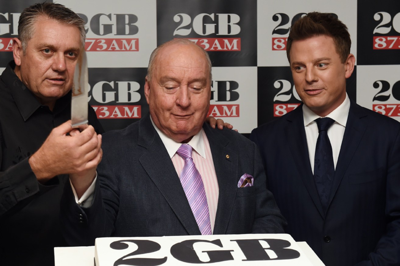 Knives are out: Ben Fordham (right) cuts a cake with fellow 2GB hosts Ray Hadley (left) and Alan Jones in 2014.