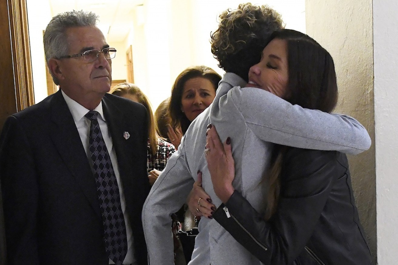 Cosby accusers Andrea Constand (centre) and Janice Dickinson (right) embrace after the sentencing.