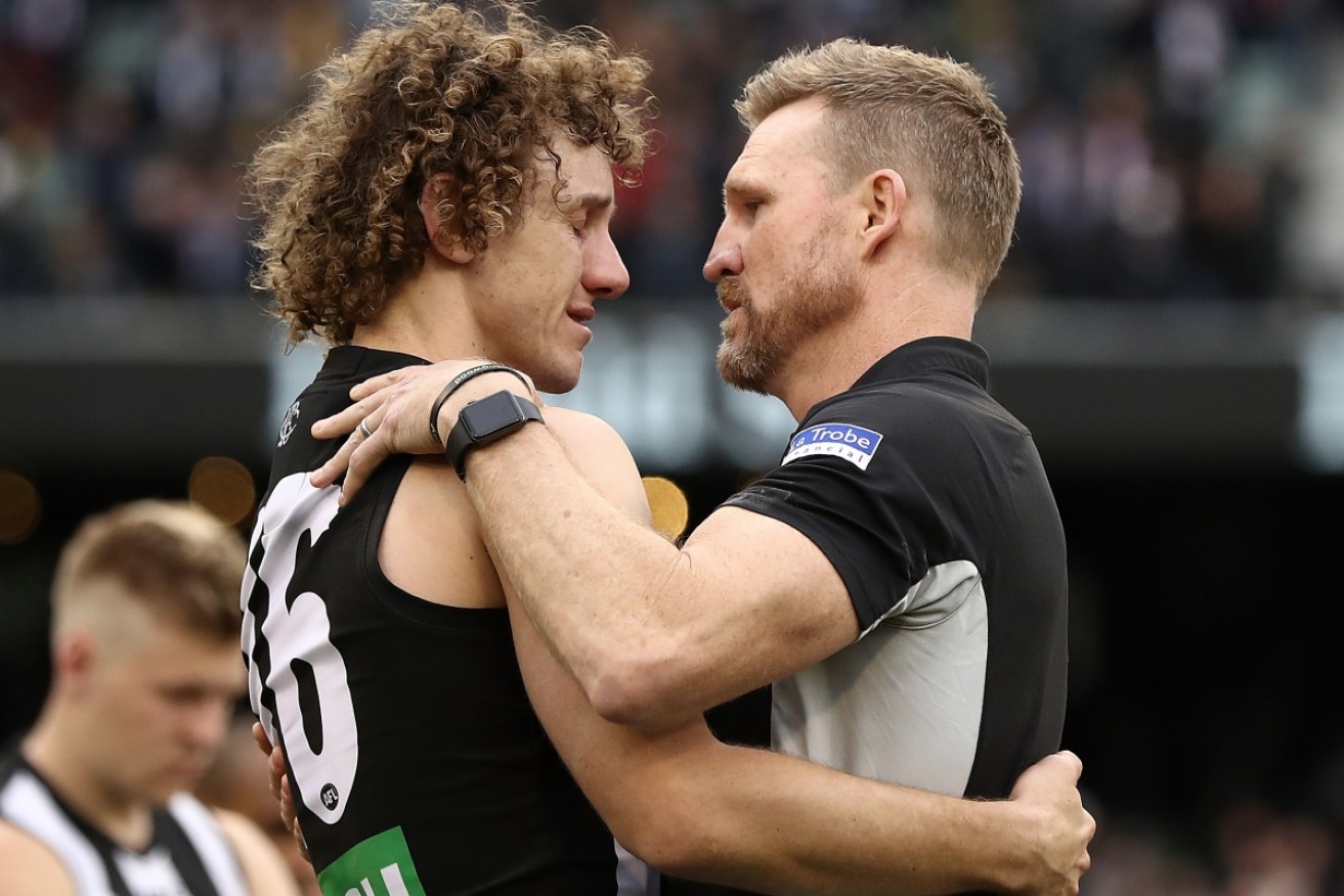 Buckley consoles Chris Mayne after the final siren.