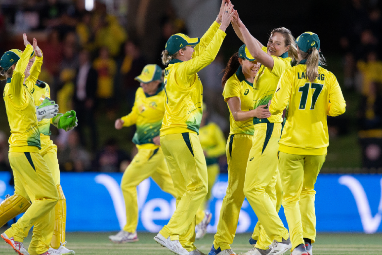 Sweet victory: Australia's women celebrate the fall of wicket before going on to set a world batting record. 