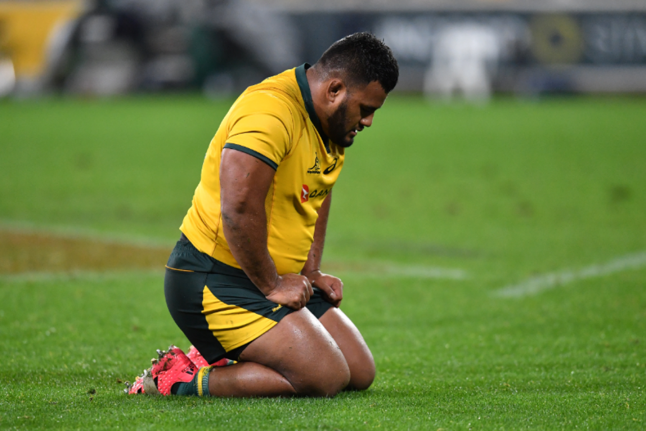 A crestfallen Taniela Tupou of the Wallabies falls to his knees in dismay after the team's latest trouncing.