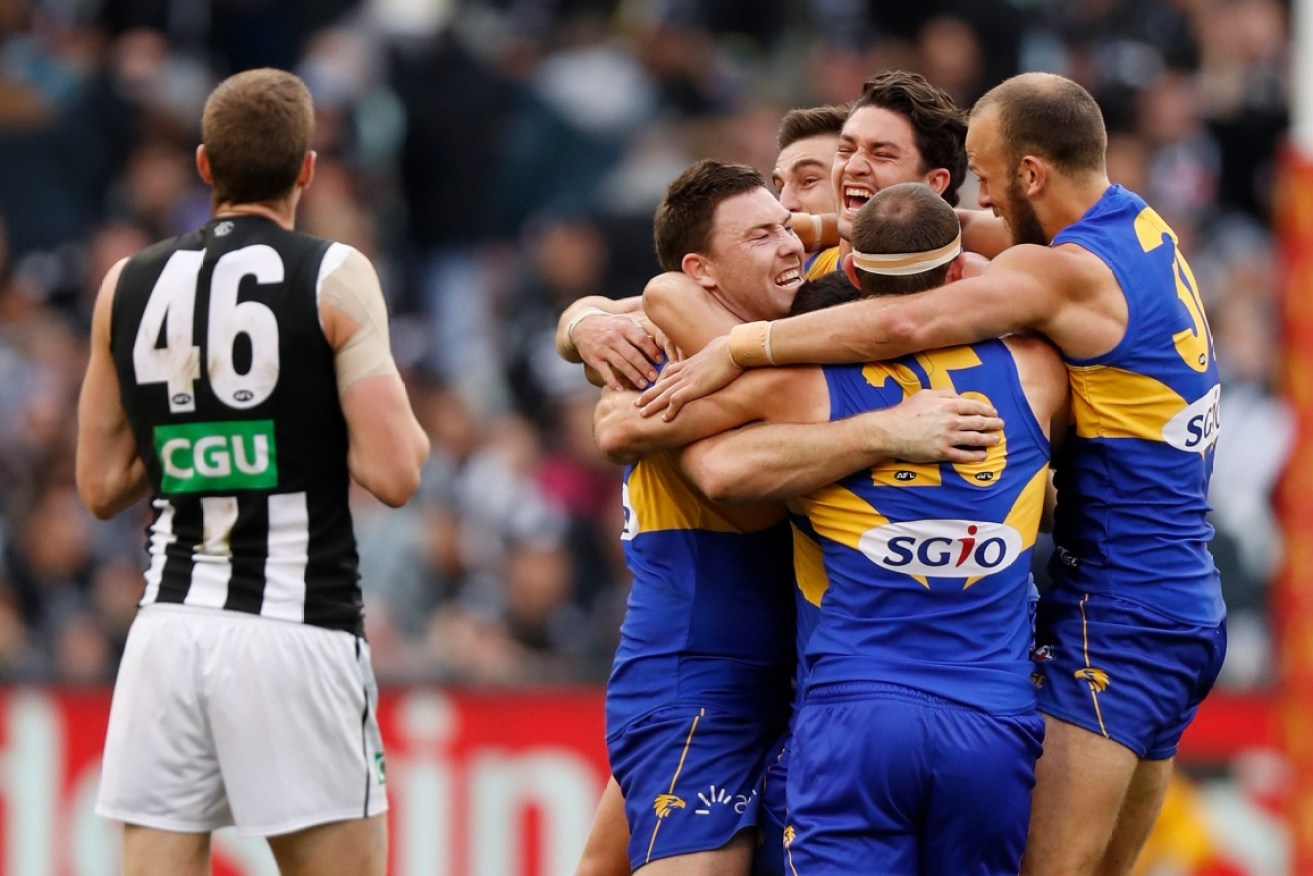 Eagles players celebrate after the final siren.