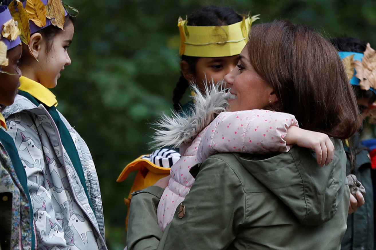 After making leaf crowns, the Duchess of Cambridge scored a hug from a schoolgirl.