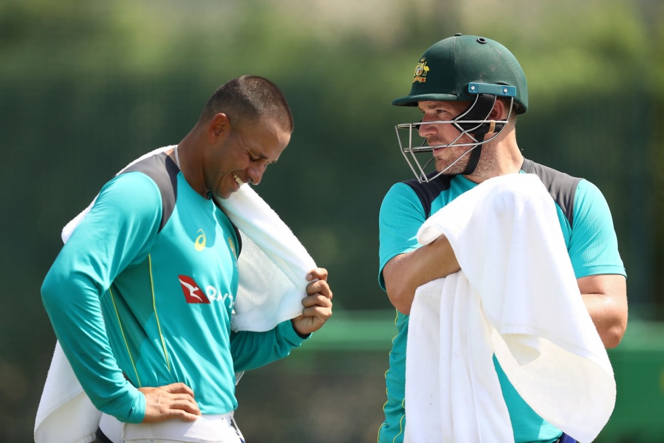 Usman Khawaja (left) and Aaron FInch share a joke during nets practice in Dubai on October 4.