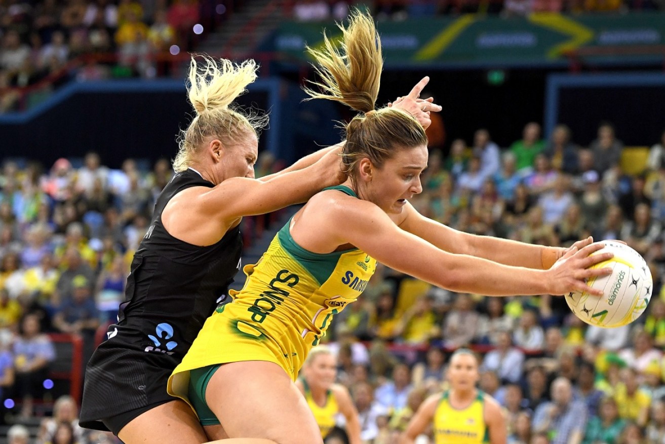 New Zealand's Laura Langman keeps the pressure on Liz Watson  during the Constellation Cup match in Brisbane on Sunday.