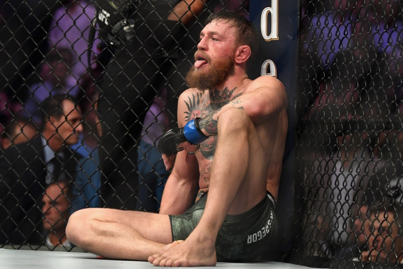 Conor McGregor recovers after Russian Khabib Nurmagomedov retained his UFC lightweight title with a submission win.  