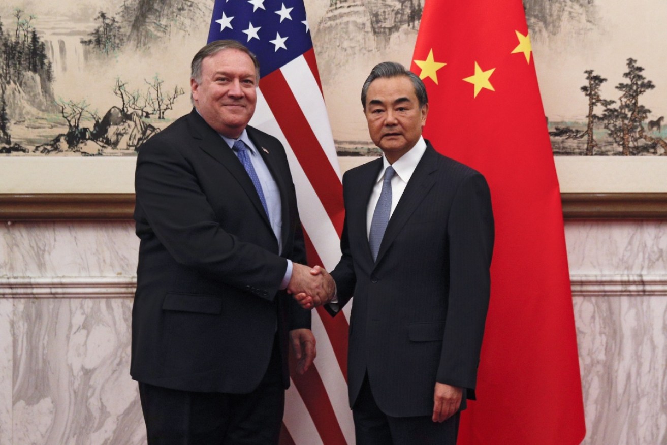 US Secretary of State Mike Pompeo and China's Foreign Minister Wang Yi before they meet in Beijing on Monday.  
