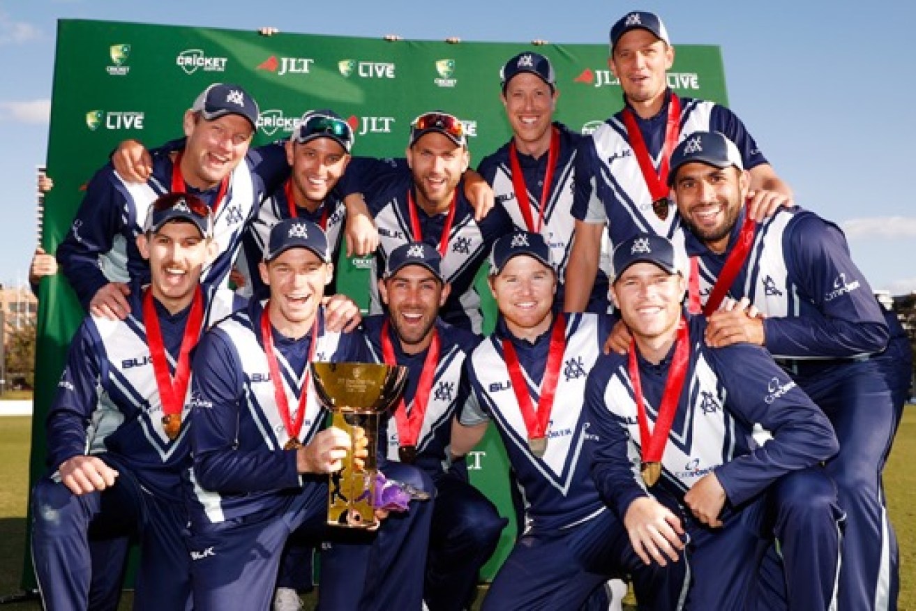 The elated Victorian side celebrates its JLT Cup success at Junction Oval on Wednesday. 