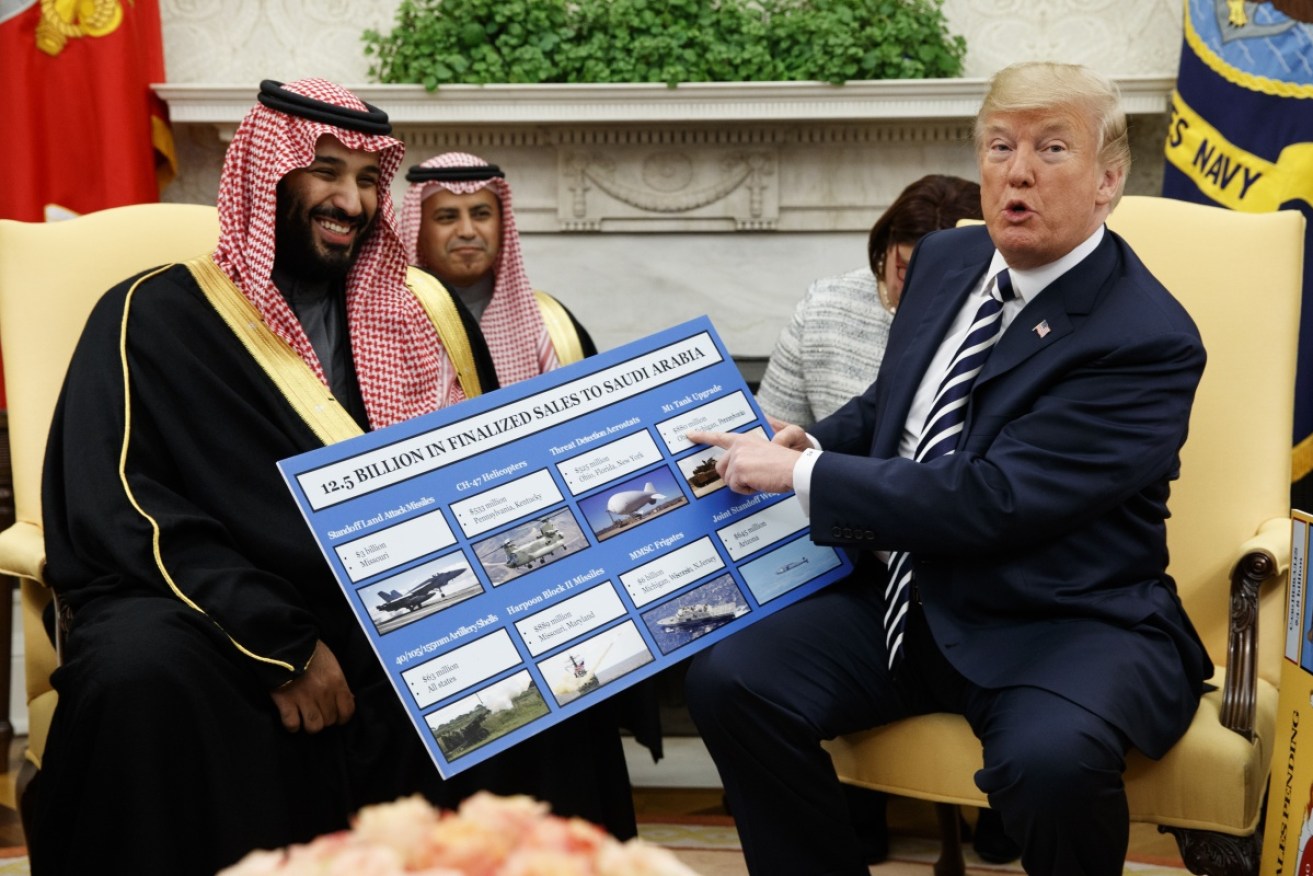 President Donald Trump holds a chart highlighting arms sales to Saudi Arabia during a meeting with Saudi Crown Prince Mohammed bin Salman in March.