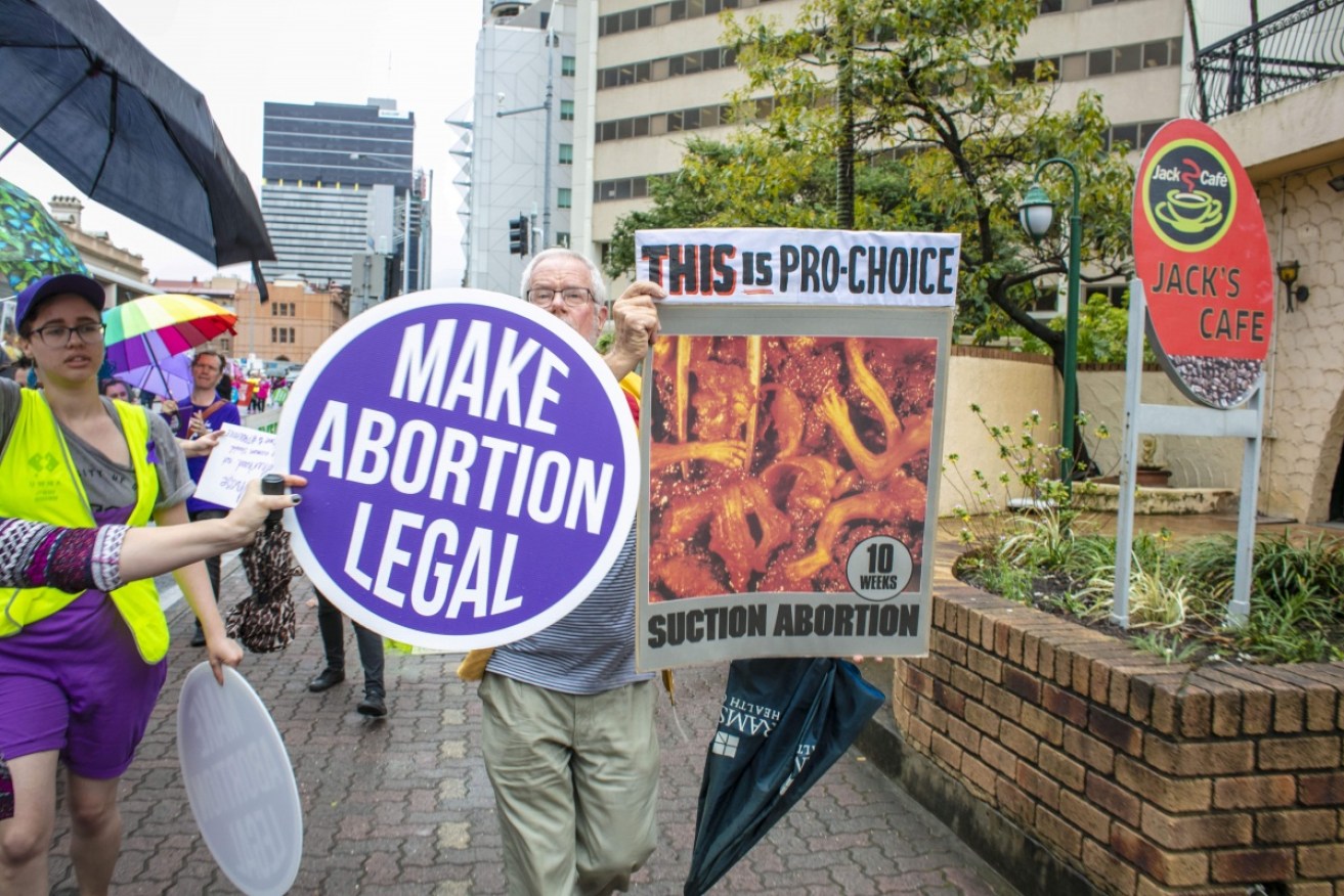 Pro-choice and anti-abortion protesters are pictured in Brisbane on Sunday.