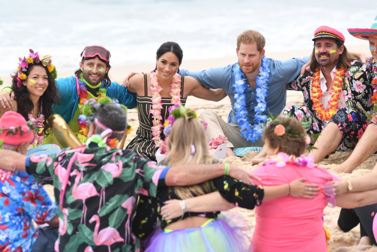 Namaste! The Duke and Duchess of Sussex sit in on the 'anti-bad-vibe circle' at Bondi Beach.