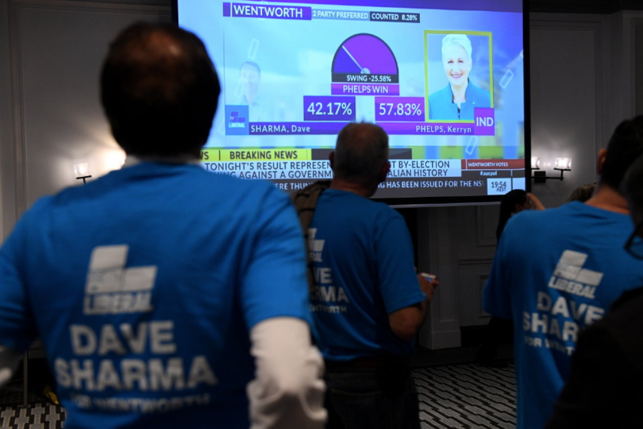 Liberal backers watch Saturday's count with dismay - before postal votes shrunk Kerryn Phelps' winning margin.
