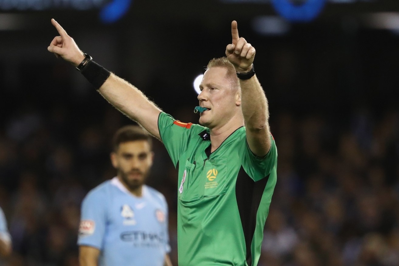 Referee Kurt Ams opts for a video review in Saturday night's Melbourne derby. 