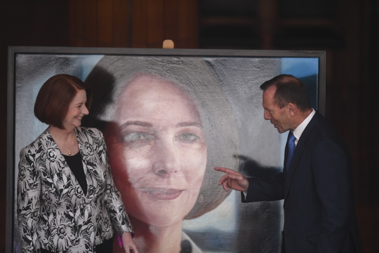 Former prime ministers Julia Gillard and Tony Abbott unveil Ms Gillard’s official portrait at Parliament House.