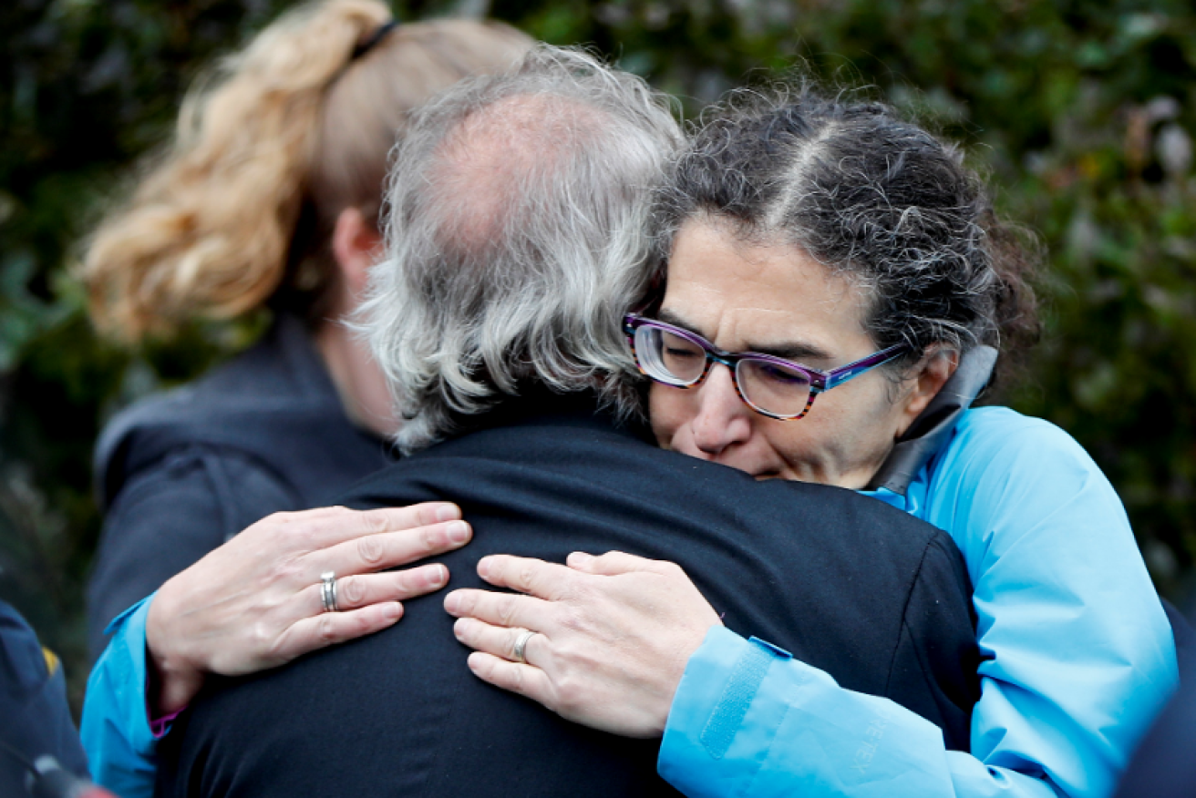 Stunned and sobbing survivors find comfort in each other's arms after the horrific rampage.