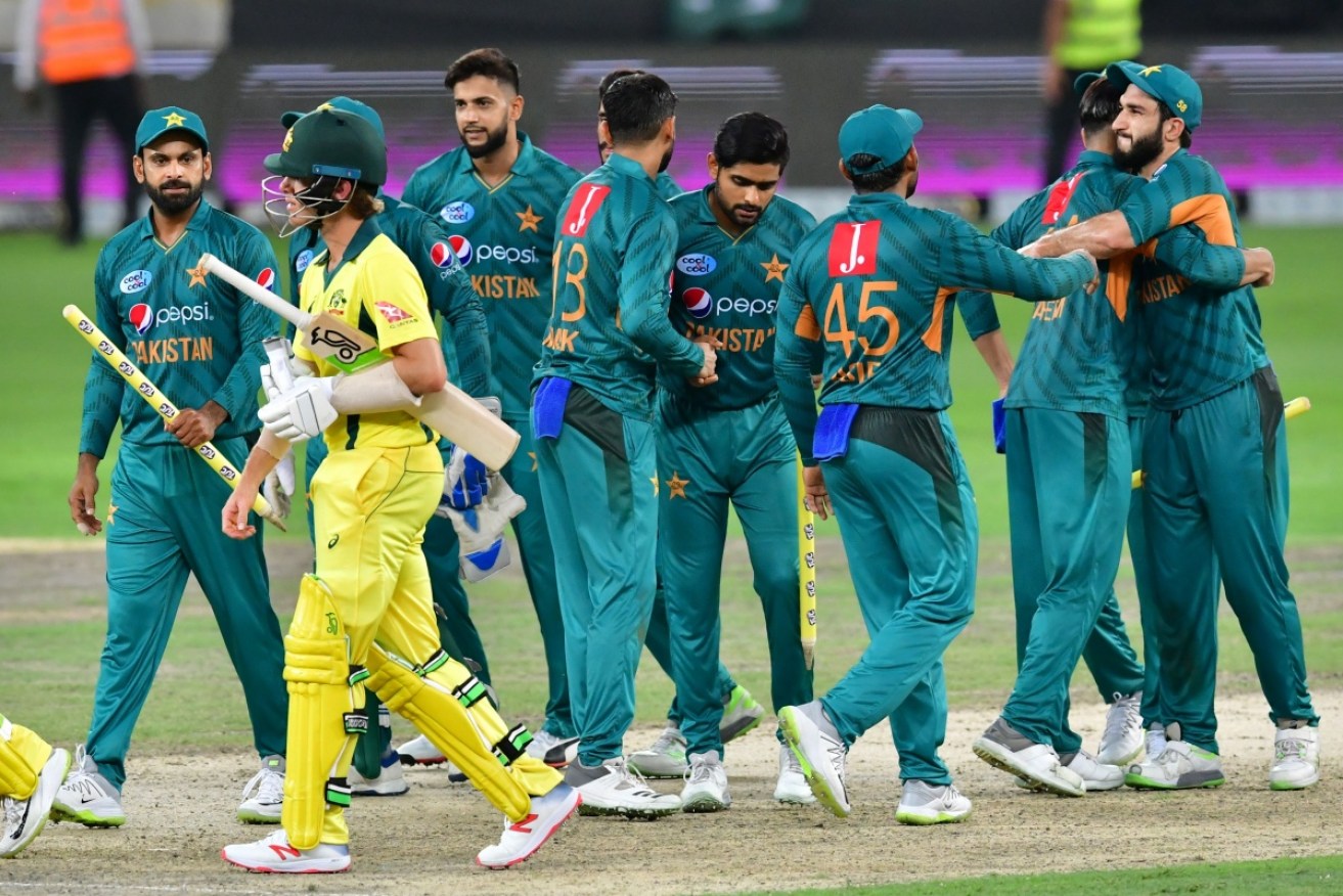 Pakistan's cricketers celebrate at the end of the third T20 cricket match between Pakistan and Australia at The International Cricket Stadium in Dubai.