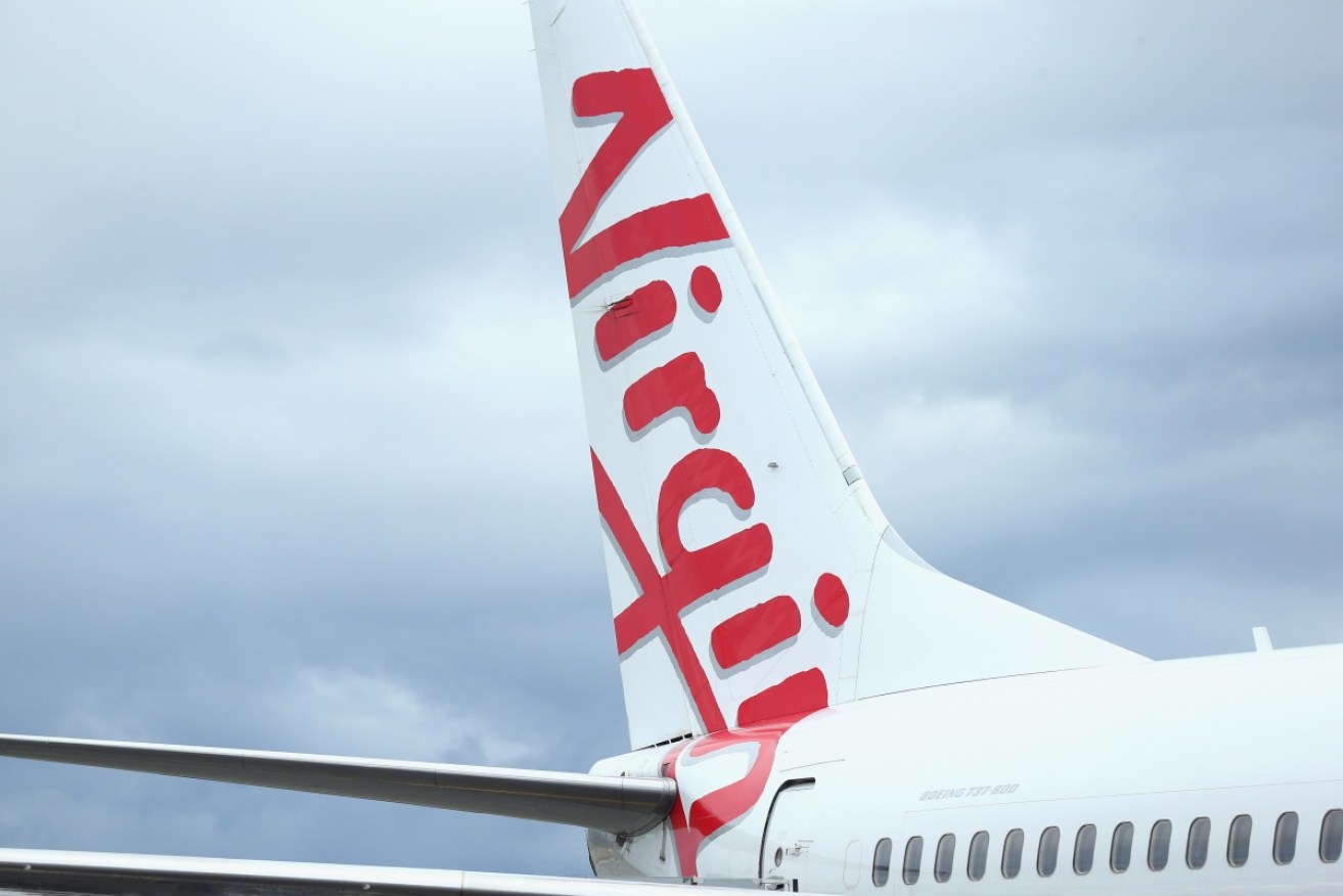 Virgin Australia is cutting flights as it anticipates at least a $50 million hit from the COVID-19 outbreak.
