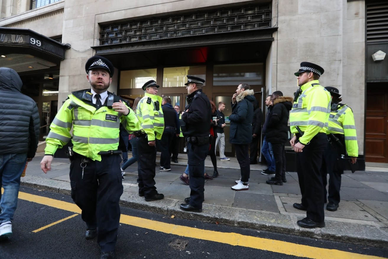 Police evacuate the headquarters of Sony Music in London after a stabbing incident.