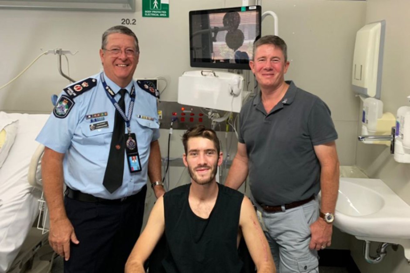 Commissioner Ian Stewart in hospital with Constable Peter McAulay and his father, Mike.

