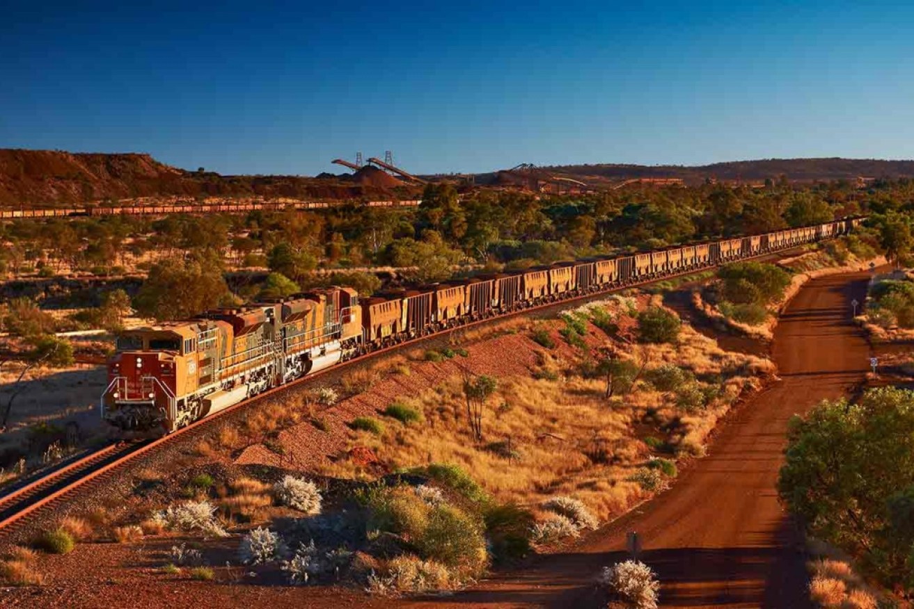 An iron ore train leaves BHP's Newman operation in Western Australia.   