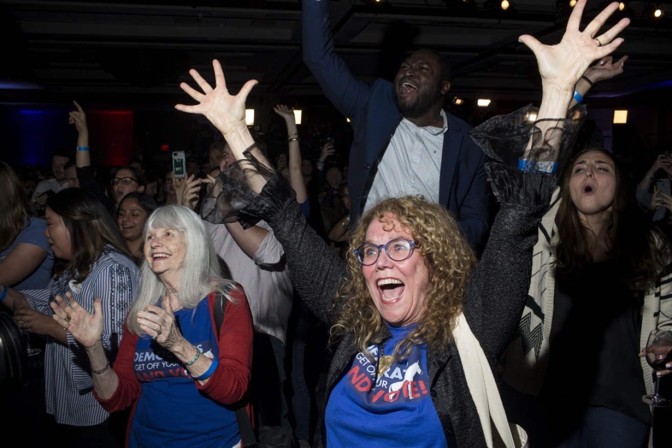 Democrat supporters celebrate as the Congressional result comes in. 