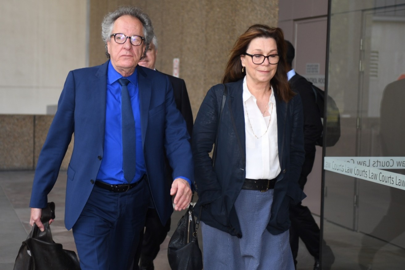 Australian actor Geoffrey Rush (L) arrives with his wife Jane Menelaus at the Federal Court in Sydney on Friday.